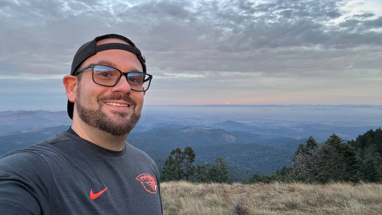 Cam, founder of Standard Charging, overlooking the Oregon landscape from Marys Peak